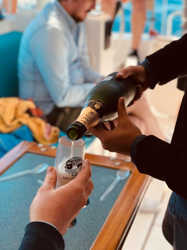 Capturing a moment of celebration with champagne pouring on a yacht in Sanary-sur-Mer, France. agence événementielle vin